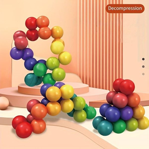 kostka edukacyjna układanka logiczna kulki antystresowe montessori, zabawki Nino Bochnia, pomysł na prezent na rozluźnienie dla dziecka, magiczne kulki